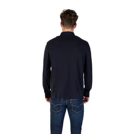 Man wearing Navy Long Sleeved Polo Shirt in dark blue with jeans, front view