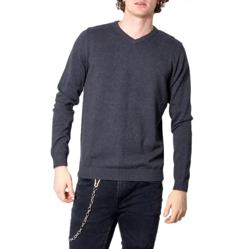 Man wearing Jack & Jones blue V-neck knitwear in a gray V-neck sweater for men