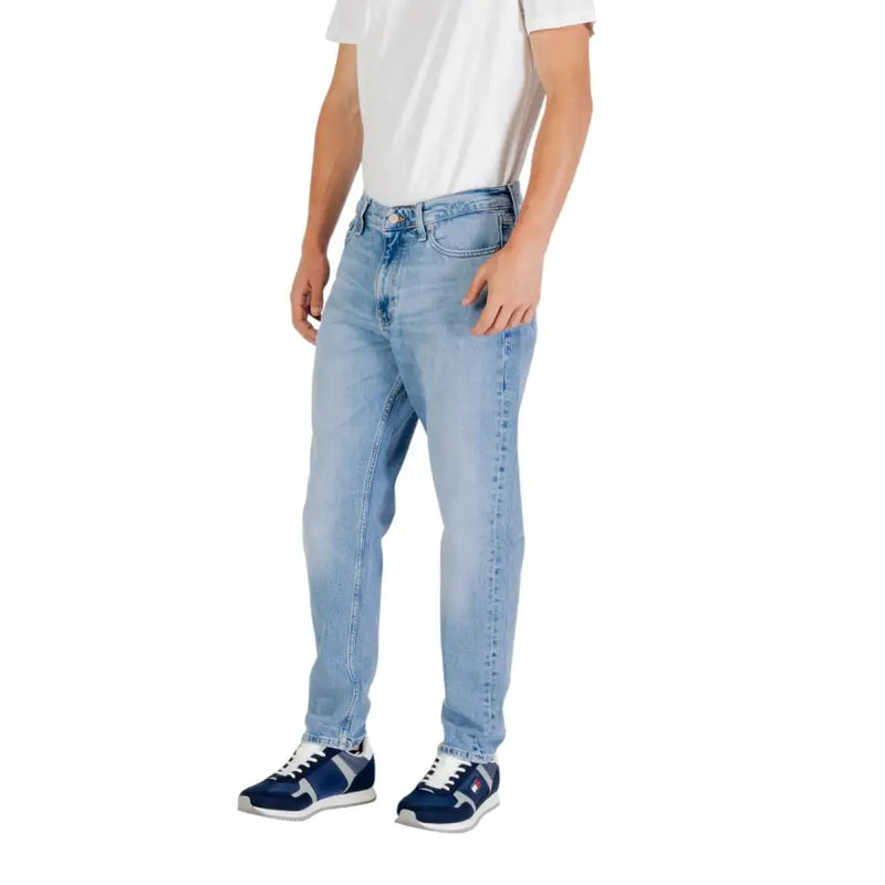 Man wearing light blue denim jeans in product display