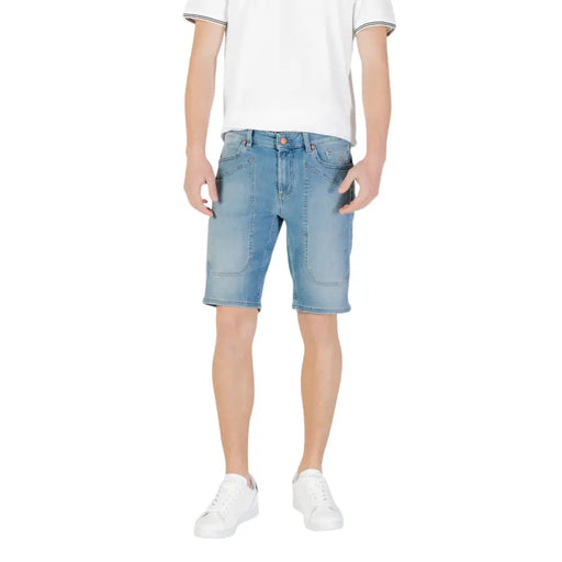 Man wearing light blue denim shorts and white sneakers for Men’s Light Blue Denim Shorts with White Sneakers