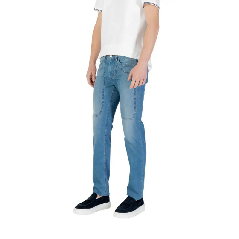 Man wearing light blue jeans and black slip-on shoes for Men’s Light Blue Jeans and Black Slip-On Shoes product