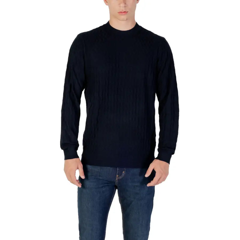 Man wearing navy textured long sleeve sweater and jeans showcasing stylish casual wear