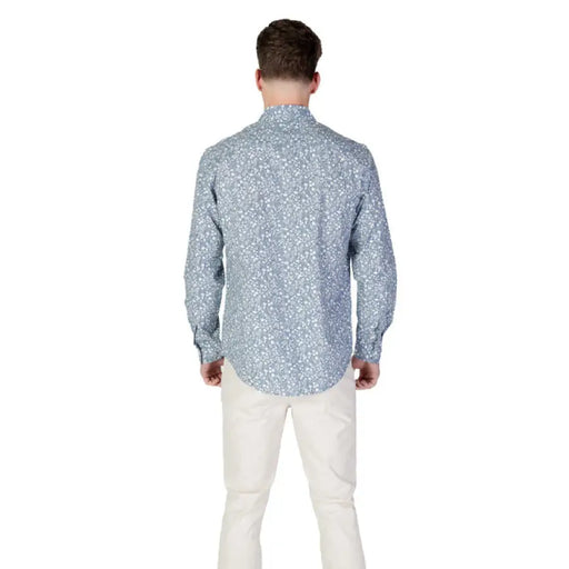 Man in a Replay Men’s Light Blue Floral Shirt with patterned long sleeves and light pants