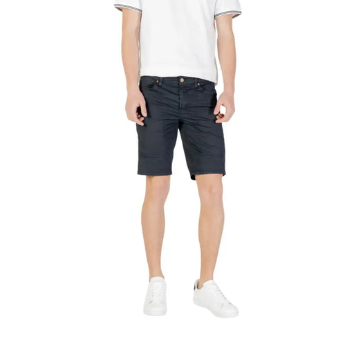 Man wearing a white T-shirt and dark shorts from the Mens Casual Shorts T Shirt and Sneaker Collection