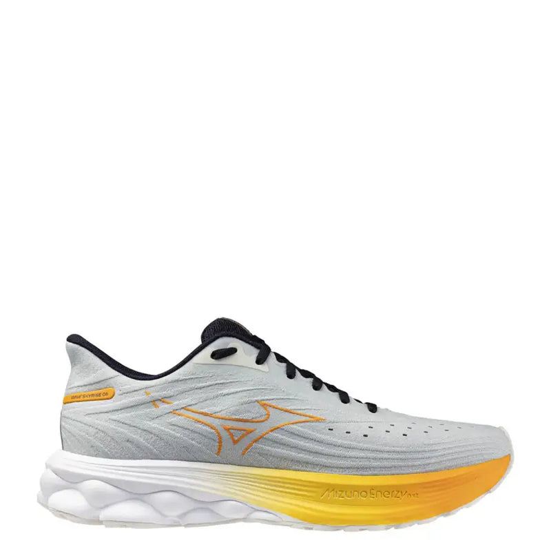 White and gold mizuno running shoe with gradient sole design.