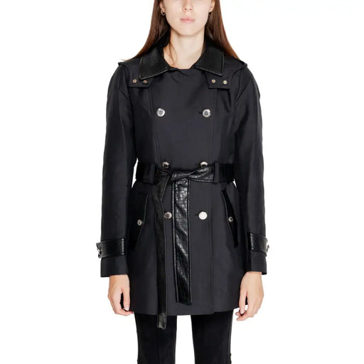 Woman wearing Morgan De Toi black double-breasted trench coat with belted waist