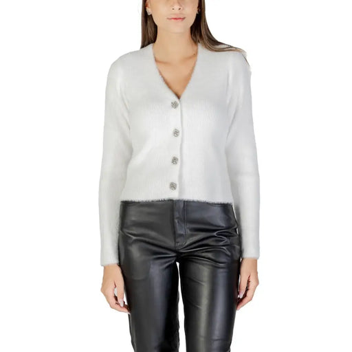 Women wearing Morgan De Toi white fuzzy V-neck cardigan with black faux leather pants