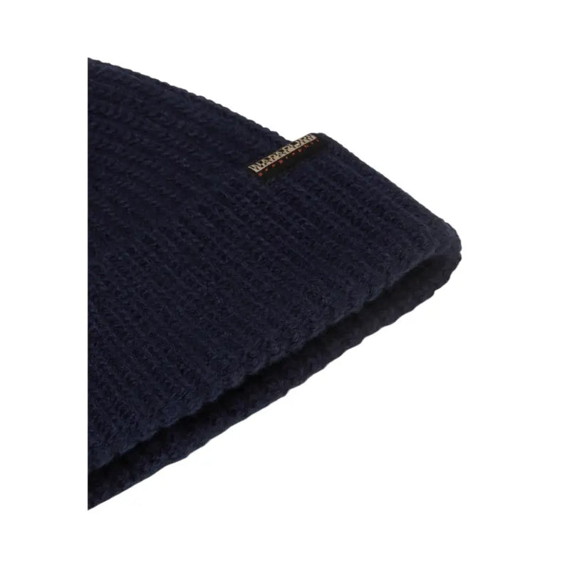 Navy blue textured beanie with a folded cuff and brand label.