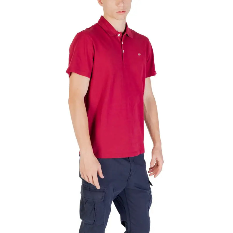 Red polo shirt with white logo and navy cargo pants.