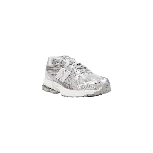 Silver new balance sneaker with mesh upper and white sole.