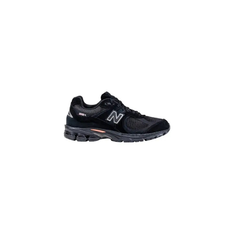 Black new balance running shoe with white accents and mesh upper.