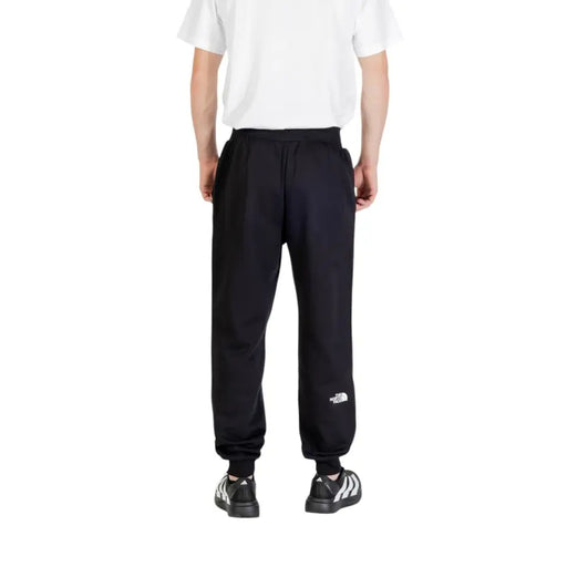 Men’s black sweatpants with elastic cuffs and white logo from The North Face Fall Winter collection