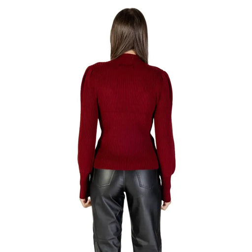 Woman wearing Bordeaux long round neck knit sweater with puffed shoulders and black leather pants
