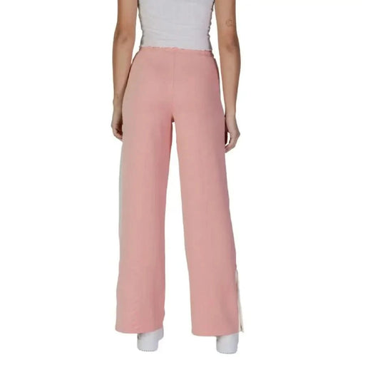 Pink wide-leg pants with white side stripes from Guess Active featuring front pockets