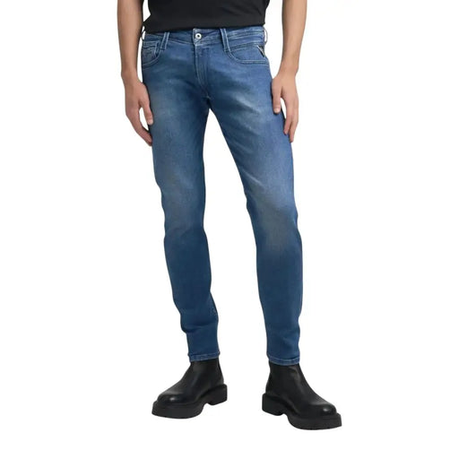 Blue denim jeans with black stitching and pockets, designed for a slim fit.