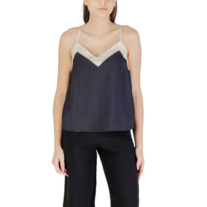 Sleeveless black and beige top displayed in the product image