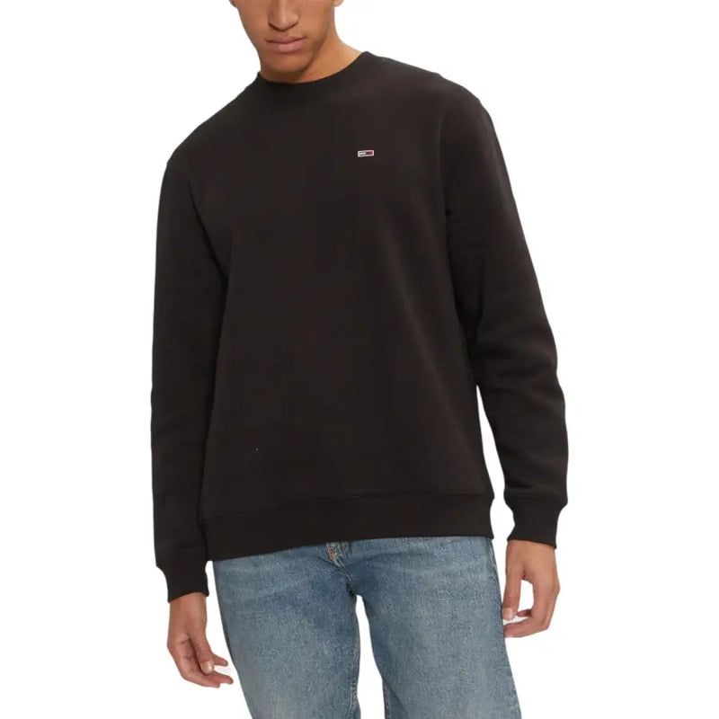 Men’s black crewneck sweatshirt with small rectangular Tommy Hilfiger logo patch
