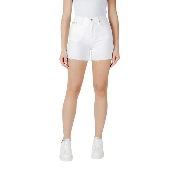 White denim shorts with frayed hem displayed in a stylish clothing product image
