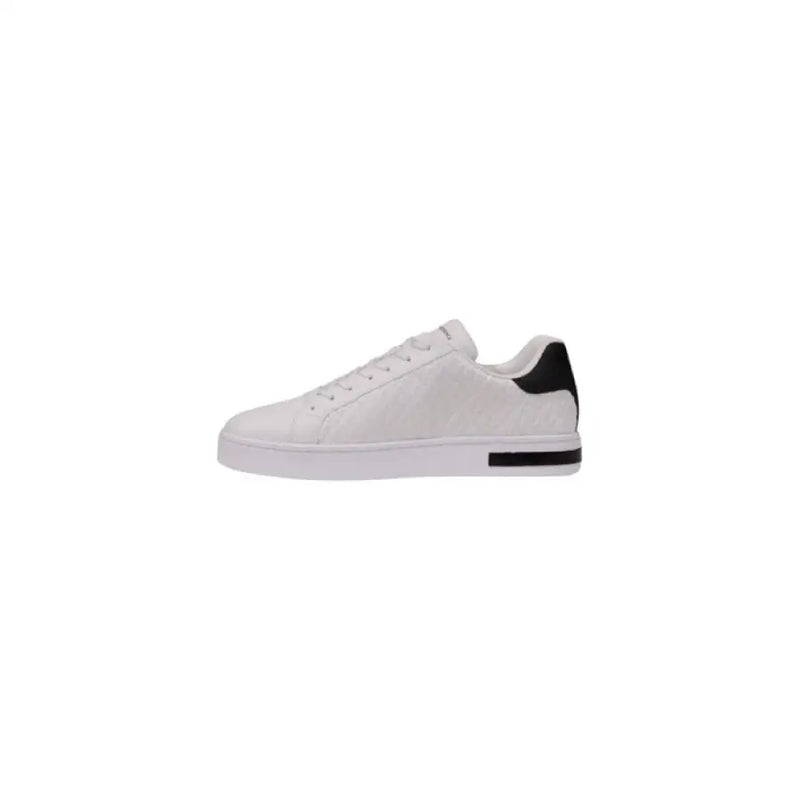 White leather sneaker with black heel accent, showcased in the White Leather Sneaker with Black Accents product image