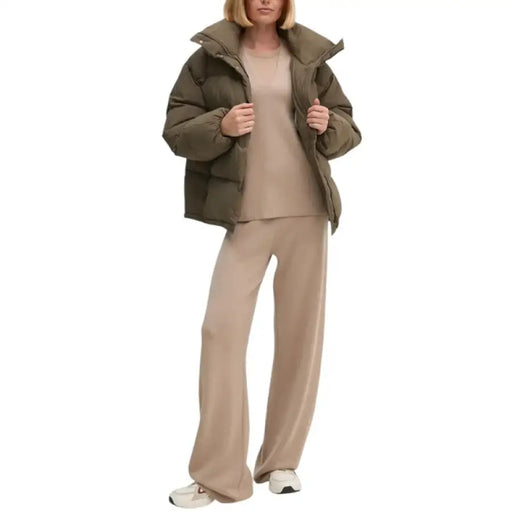 Woman wearing a beige outfit and Olive Green Puffer Jacket showcasing stylish fall fashion