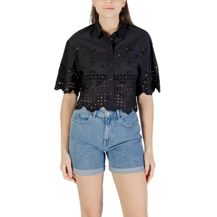 Woman wearing a black eyelet shirt and denim shorts for Women’s Black Eyelet Shirt and Denim Shorts product
