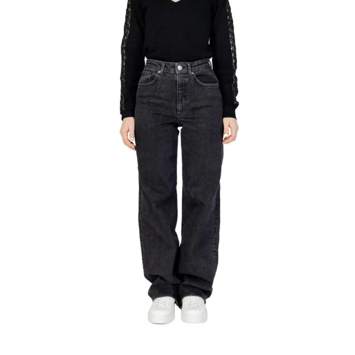 Woman wearing Women’s Black Wide Leg Jeans and black top showcasing stylish attire
