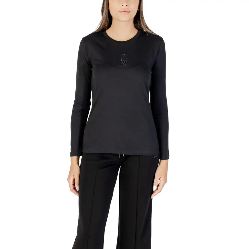 Woman wearing a black long-sleeved crew-neck top and black track pants, showcasing Armani Exchange T-shirt