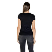 Woman wearing Armani Exchange black rhinestone print short sleeve T shirt and dark gray skinny jeans