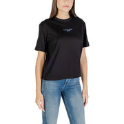 Woman wearing Calvin Klein Jeans black round neck short sleeve T shirt and blue jeans