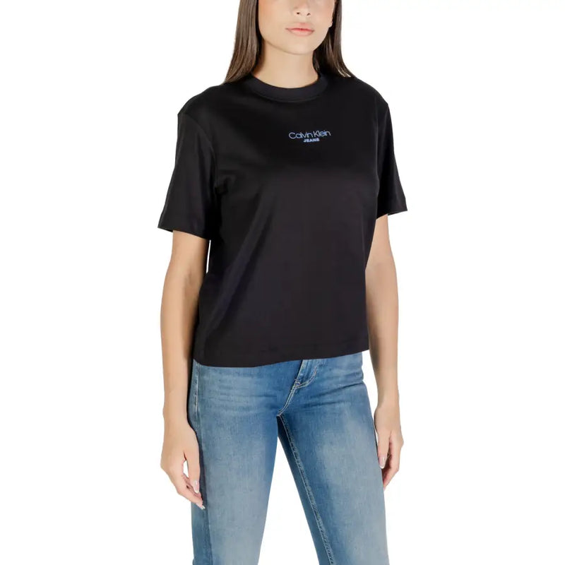 Woman wearing Calvin Klein Jeans black round neck short sleeve T shirt and blue jeans