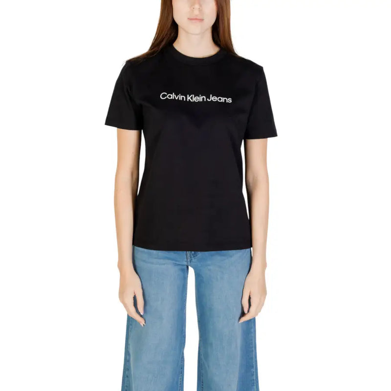 Woman wearing Calvin Klein Jeans black cotton short sleeve crew neck T shirt and light blue wide-leg jeans