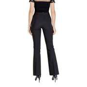 Woman wearing Rinascimento black fall winter trousers with pleats and a sheer dotted neckline top