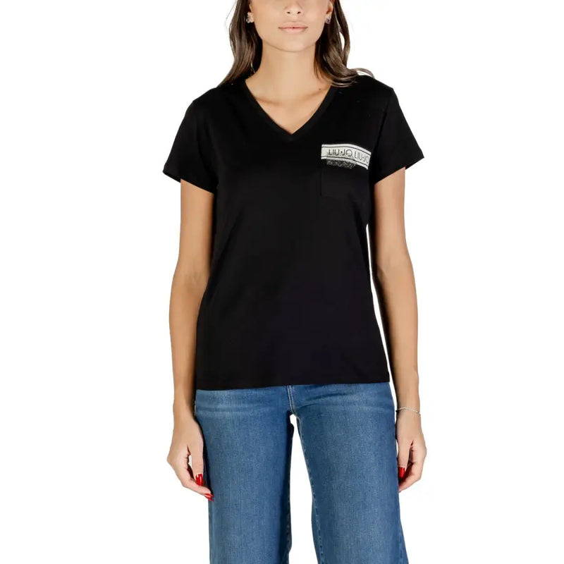 Woman wearing a black V-neck cotton T-shirt with pocket and blue jeans