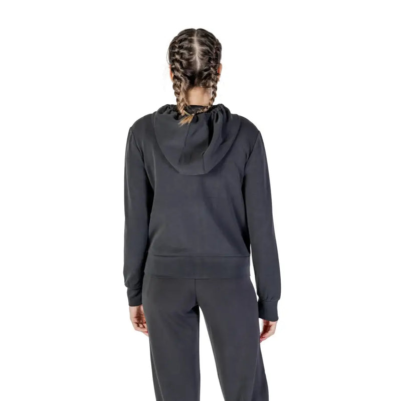 Woman wearing Guess Active Women Black Long Hooded Zip Sweatshirt in dark gray tracksuit