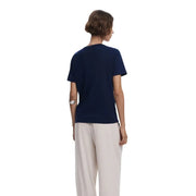 Woman wearing navy blue short-sleeve V-neck cotton T-shirt with beige wide-leg pants
