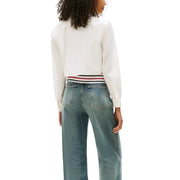 Woman in Tommy Hilfiger White Long Sleeve Button Shirt with wide-leg blue jeans