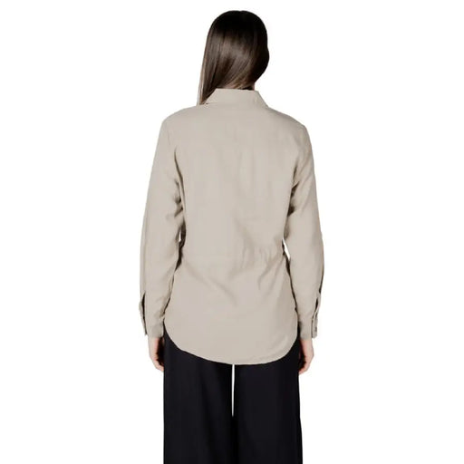Woman wearing a beige button-down drawstring shirt from Womens Beige Button Down Drawstring Shirt collection