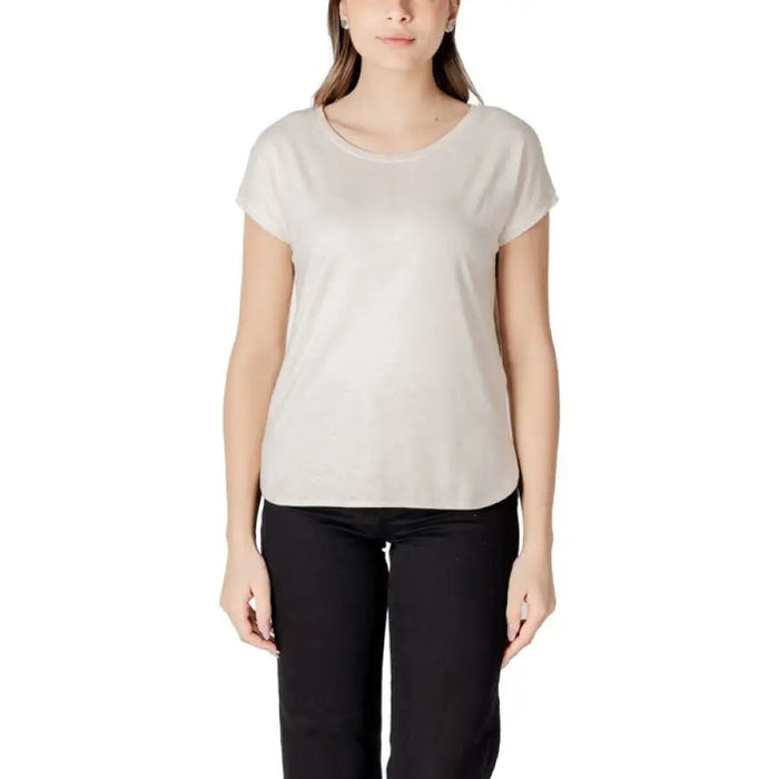 Woman wearing beige T shirt and black pants displayed in Womens Beige T Shirt and Black Pants product image