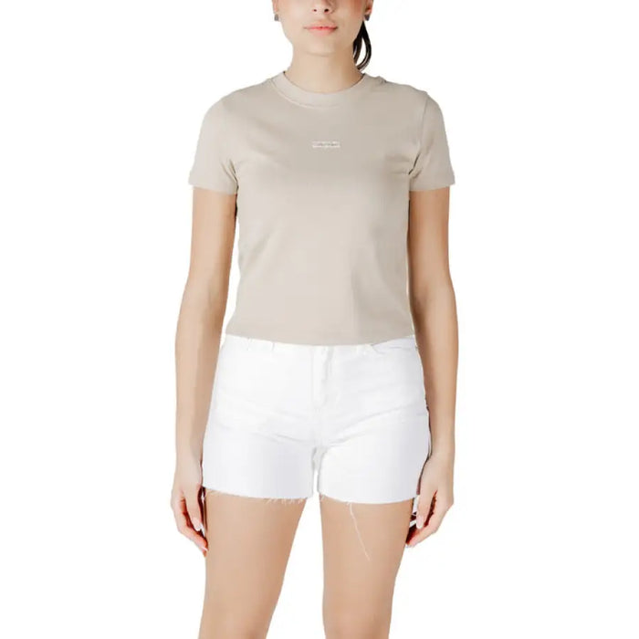 Woman wearing beige T shirt and white denim shorts from Womens Beige T Shirt and White Denim Shorts product collection