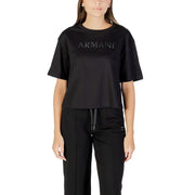 Woman wearing black crew-neck T-shirt with matching track pants, casual style