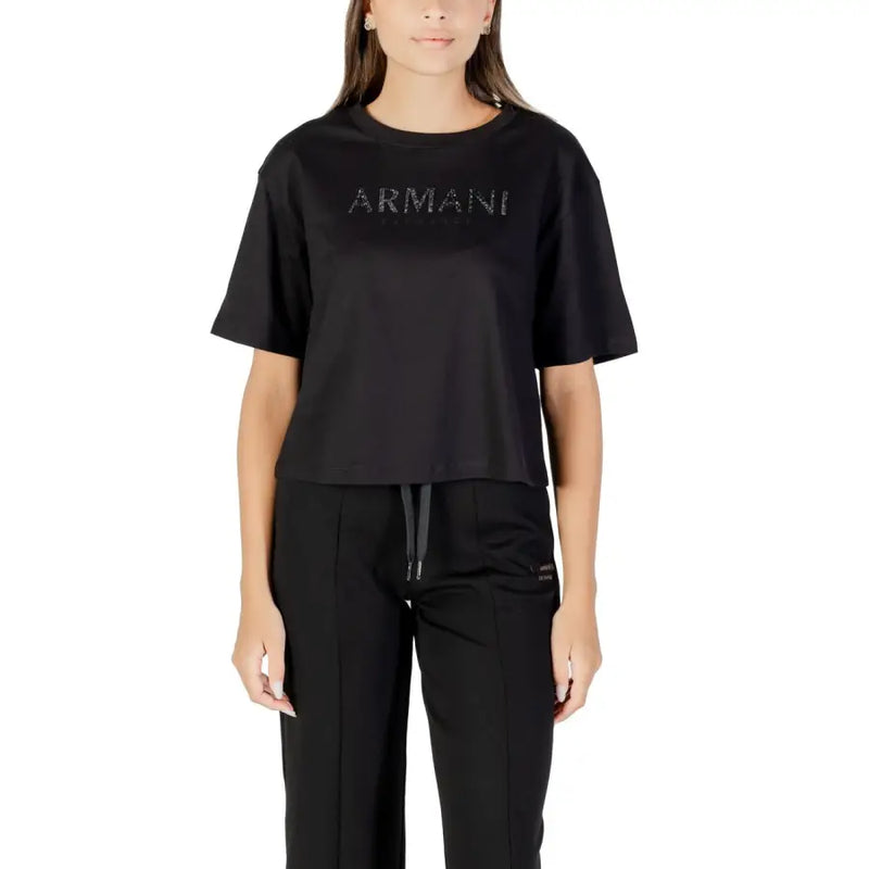 Woman wearing black crew-neck T-shirt with matching track pants, casual style