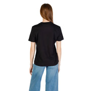 Woman wearing Calvin Klein Jeans short sleeve black cotton T-shirt with light wash wide-leg denim jeans