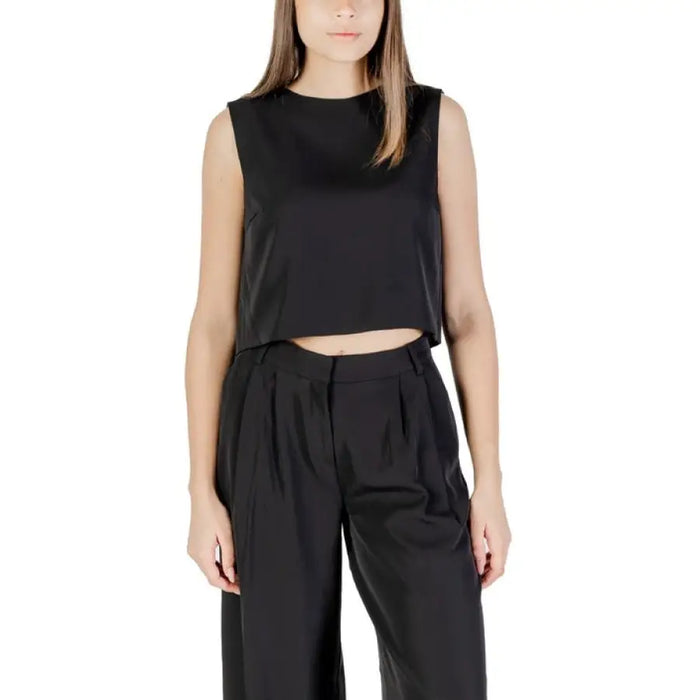 Woman wearing a black crop top and matching pants outfit from Womens Black Crop Top and Pants product line