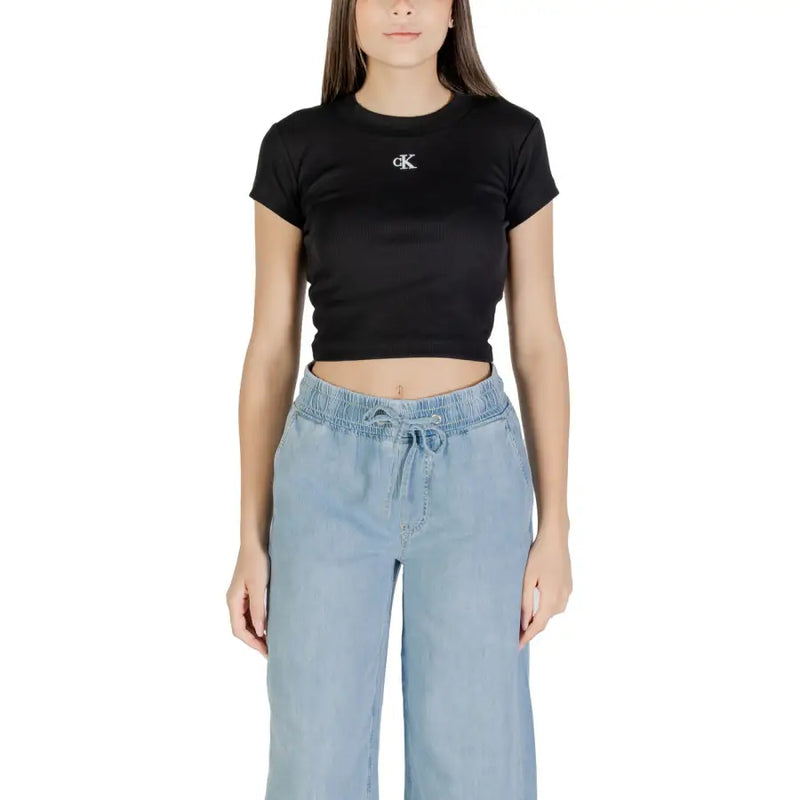 Woman wearing Calvin Klein Jeans black printed short sleeve crop top with CK logo