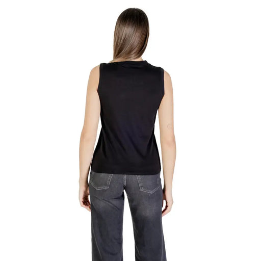 Woman wearing Calvin Klein Jeans black cotton sleeveless round neck tank top and dark grey jeans
