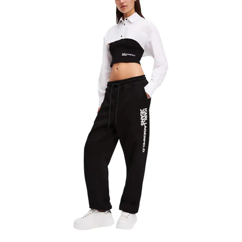 Woman wearing Karl Lagerfeld black and white two-piece outfit with cropped shirt and sweatpants