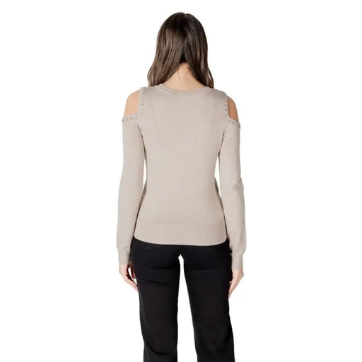 Woman wearing a cold-shoulder long-sleeve sweater from Women Cold Shoulder Sweater Collection