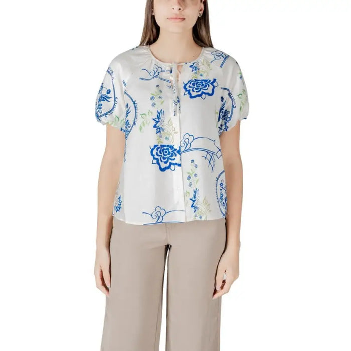 Woman wearing floral-patterned blouse and tan pants from Womens Patterned Blouse and Pants collection