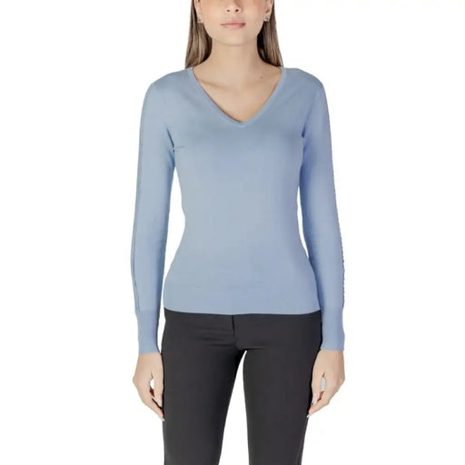 Woman wearing a light blue V-neck sweater from Womens Light Blue V Neck Sweater collection