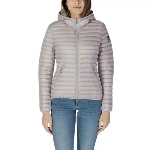Woman wearing a light gray Colmar Originals hooded puffer jacket